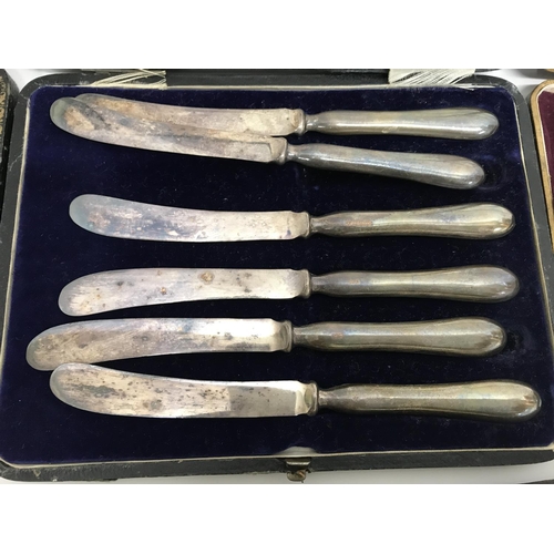 794 - Cased cutlery comprising six silver coffee spoons two cased set of butter knifes with silver handles... 