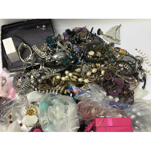 813 - A bag containing a large quantity of dress jewellery including some silver (a lot)