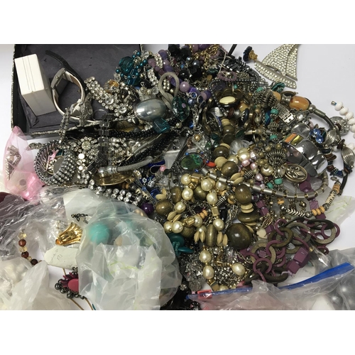 813 - A bag containing a large quantity of dress jewellery including some silver (a lot)