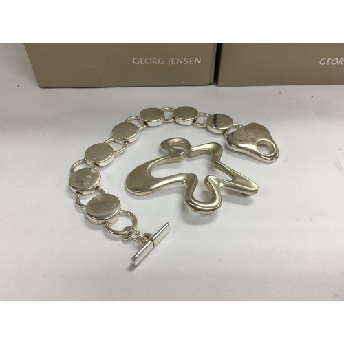 814 - A Georg Jensen Sterling silver bracelet and a Georg Jensen Sterling silver pendant. ( with boxes).