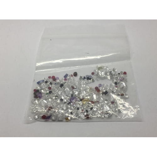 818 - A bag of loose mixed stones including cubic zirconia, sapphire, ruby, amethyst, citrine and emerald,... 