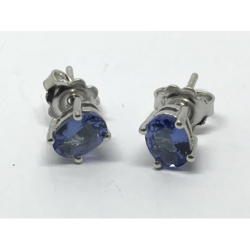 823 - A pair of silver studs set with tanzanite.