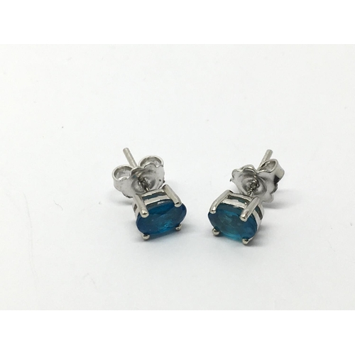 824 - A pair of silver studs set with neon blue apatite.