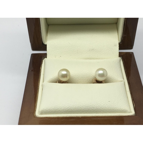 854 - A pair of 9ct gold cultured pearl earrings.