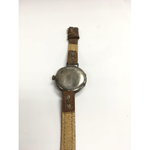 871 - A vintage silver trench wristwatch with telephone dial style shrapnel guard.