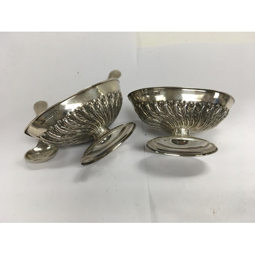 879 - A pair of hallmarked silver salts and spoons with marks for H.Wilkinson .