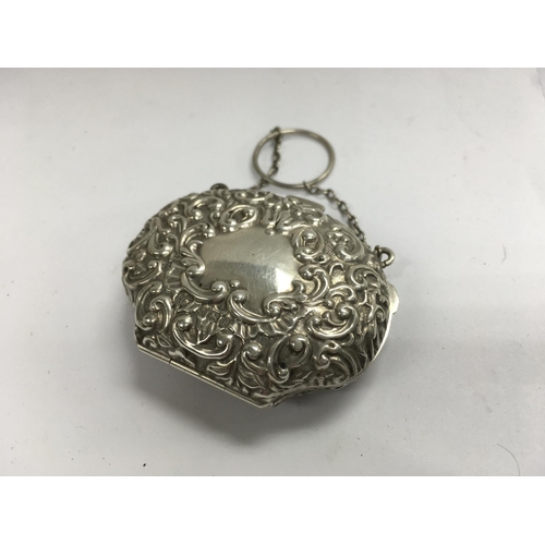 880 - A hallmarked silver purse with marks for Birmingham 1908.