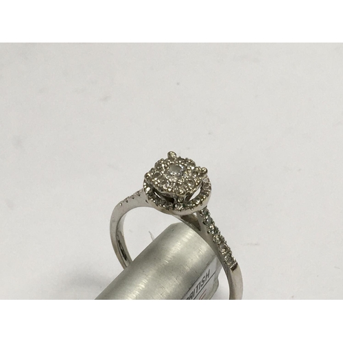 881 - An 18ct white gold (unmarked tested ) illusion set diamond ring. Q.