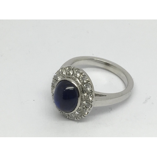 888 - An 18ct white gold diamond and cabuchon sapphire cluster ring, approx 8.9g and approx size O