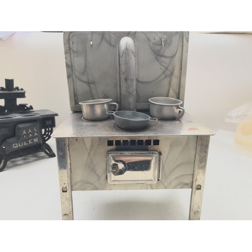 101 - A Tin Plate Stove with pots and a Cast Iron Stove.