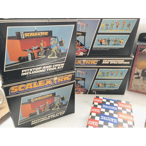 104 - A Box containing a collection of Boxed Scalextric Accessories including 2 x Pitstop and crew. 2 x Co... 