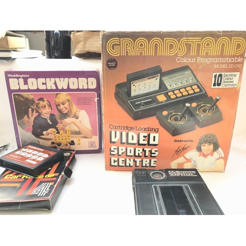 214 - A Boxed Grandstand Video Sports Centre with 2 Games. A Demon Driver Electronic game and a Blockword ... 