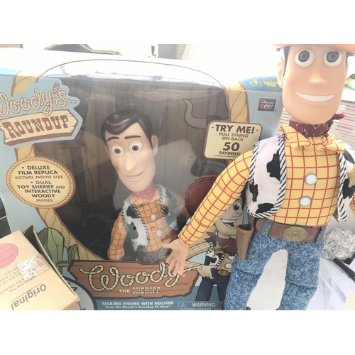 505 - A Collection of Toy Story Figures including a Loose and Boxed Woody and a Slinky Dog.