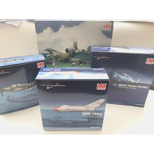 55 - A collection of 4 Hobbymaster diecast aircraft including a T-6 Texan Trainer. A Mig -15bis. A P-39Q ... 