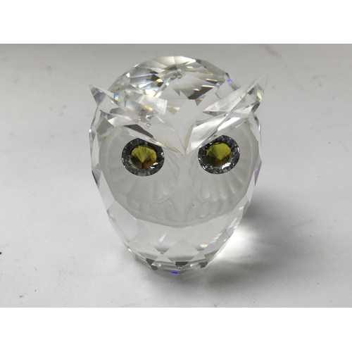 1029 - Four Swarovski Crystal owls with original boxes and certificates. Three of different sizes and one o... 