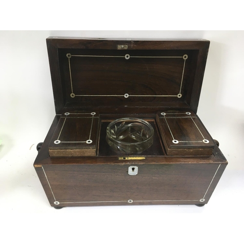 858 - A William IV rosewood tea caddy inlaid with mother of pearl.