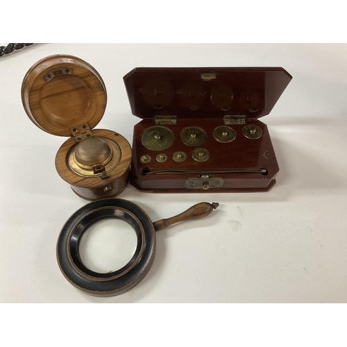 873 - A mahogany cased set of postal weights 20gms to 1000gms, an olive wood travelling inkwell plus a sma... 