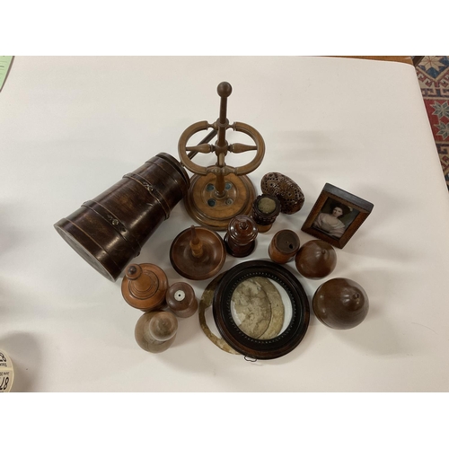 876 - A collection of treen items to include a hat pin stand, a coquina nut pomander etc.