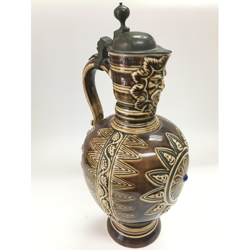 904 - A German ceramic jug in a brown glaze, approx height 37cm.