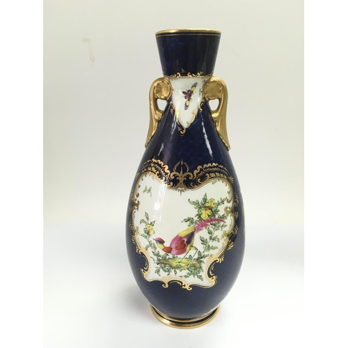 905 - A 1904 Royal Worcester vase in blue with giltwork and handpainted decoration, approx 26cm.