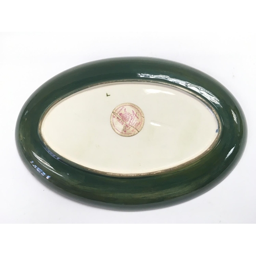 952 - A Walter Moorcroft oval shaped dish in clematis pattern, approx length 23cm. Paper label to reverse.