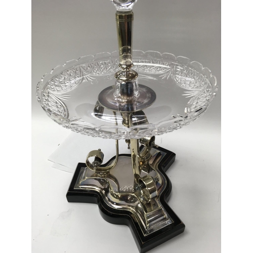 989 - A silver plated and glass epergne with single trumpet circular dish on scrolled plated base .