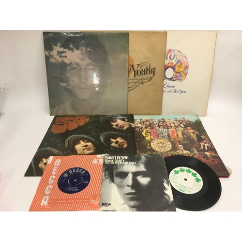 318 - A small collection of records comprising 'Rubber Soul' and 'Sgt Pepper' by The Beatles, 'A Night At ... 