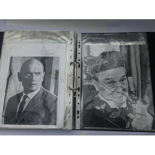 551 - Two binders of old movie publicity prints.