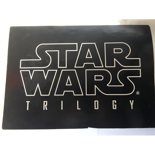 569 - A Star Wars trilogy advertising board, approx 84cm x 59cm.