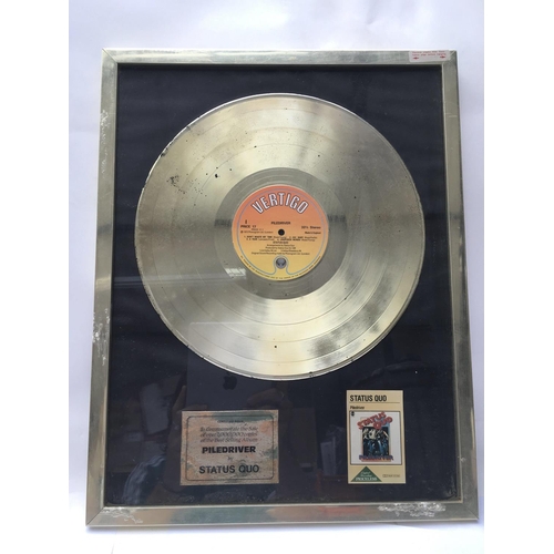 618 - A framed and glazed Status Quo gold disc in recognition of the sale of over 1,000,000 copies of the ... 