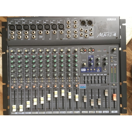 711 - A Yamaha MX12/4 mixing console with instructions.