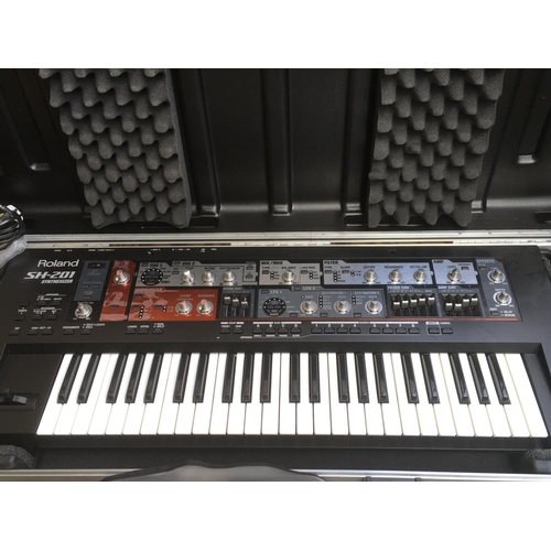 715 - A Roland SH201 synthesizer in a hard carry case.