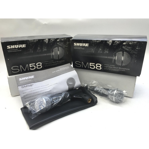 722 - Two boxed Shure SM58 microphones.