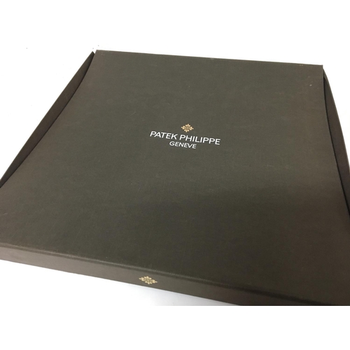 756 - A Patek Philippe silk patterned scarf. In a presentation box.