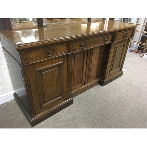 1208 - A Victorian oak sideboard the mirror back above three drawers and cupboards under on a plinth base .... 