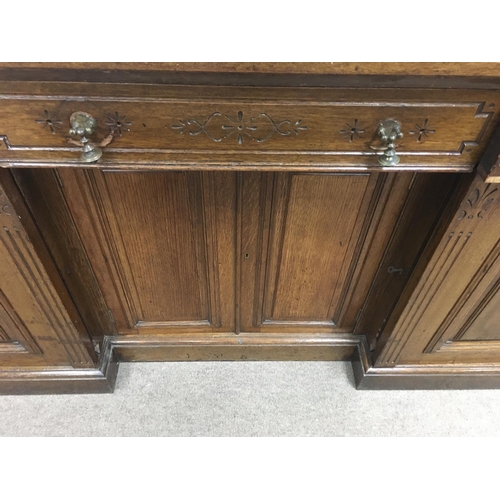 1208 - A Victorian oak sideboard the mirror back above three drawers and cupboards under on a plinth base .... 