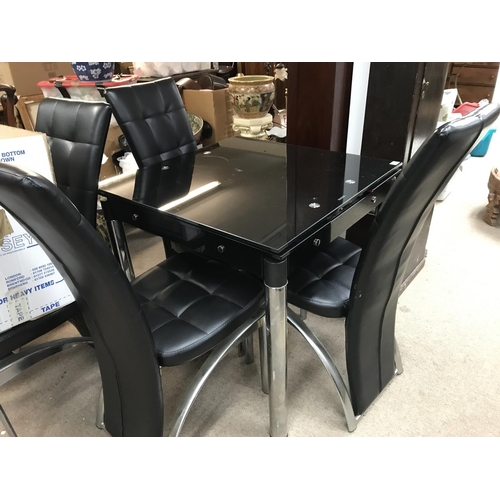 1214 - A chrome and leather modern dining table and four chairs. The table measurements are approximately 8... 
