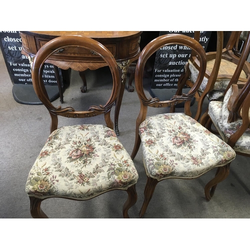 1215 - A Victorian inlaid walnut loo table and six balloon back dining chairs. The approximate height of th... 