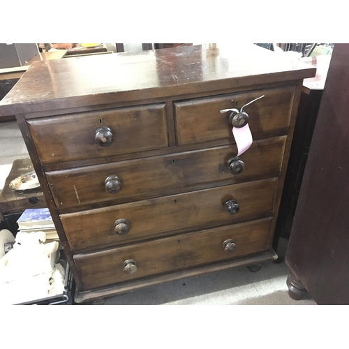 1226 - A pine chest of drawers fitted with two short and three long graduating drawers on turned feet - NO ... 