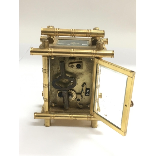 1231 - A small brass carriage clock with bamboo style decoration, approx height 11cm.