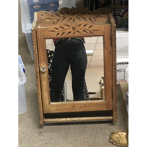 1242 - A hanging wall pine cabinet with a mirrored front. Measuring approximately 60cm x 16cm x 40cm.