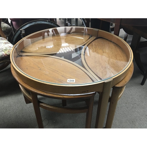 1245 - A nest of modern design Schreiber coffee tables. the circular glass top above three shaped tables.