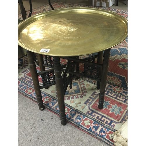 1246 - A brass topped Middle Eastern occasional table with a folding base.