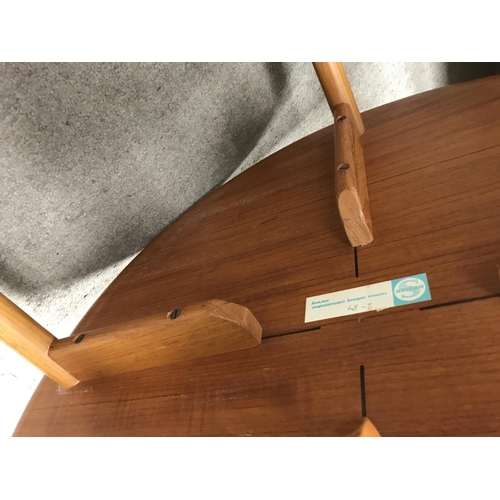 1255 - A Norwegian circular occasion table the tapering legs United by x frame stretchers