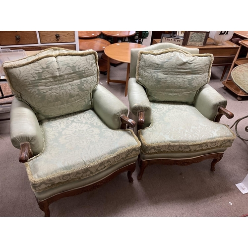 1286 - A pair of upholstered armchairs with carved walnut frames.