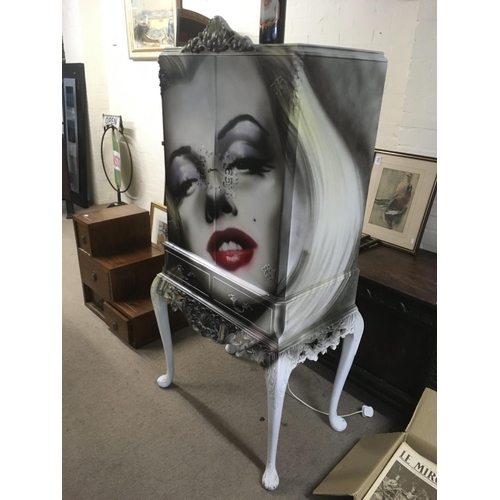 1295 - A Paul Karslake designed and painted cabinet depicting Marilyn Monroe. Fitted with two doors over tw... 