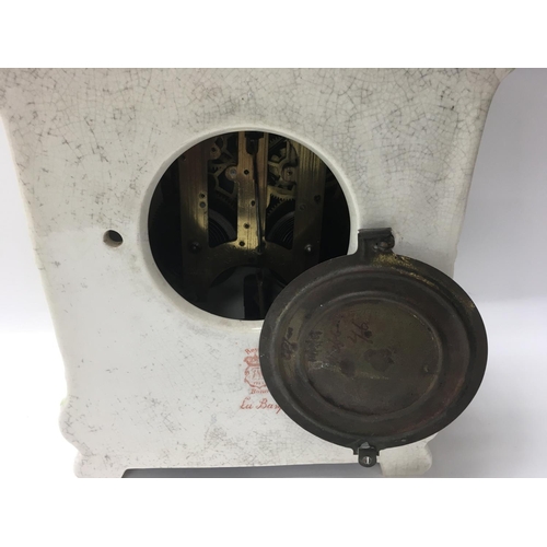 966 - A Edwardian mantel clock with pottery floral case the circular dial with Roman numerals.