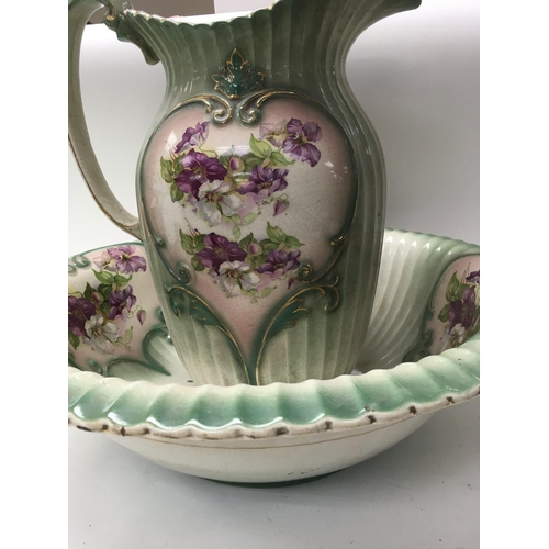 996 - A jug and bowl decorated with flowers and foliage.