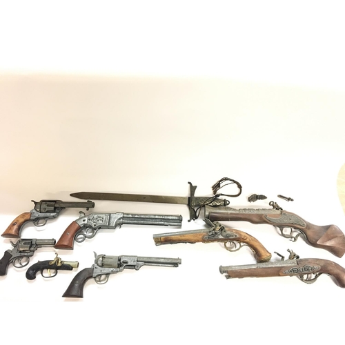 2034 - A collection of replica firearms including flintlock - revolver - musket.