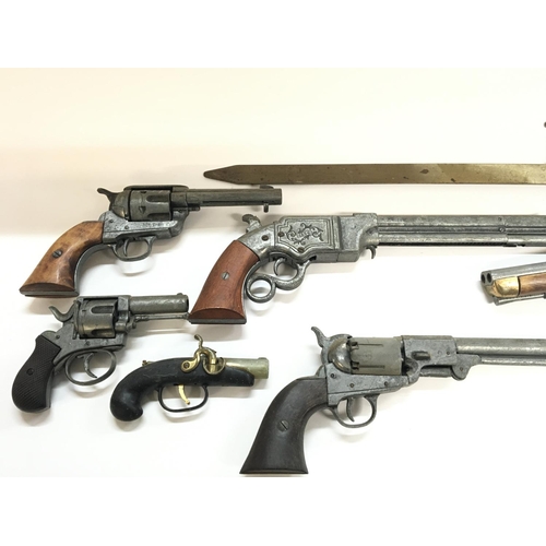 2034 - A collection of replica firearms including flintlock - revolver - musket.